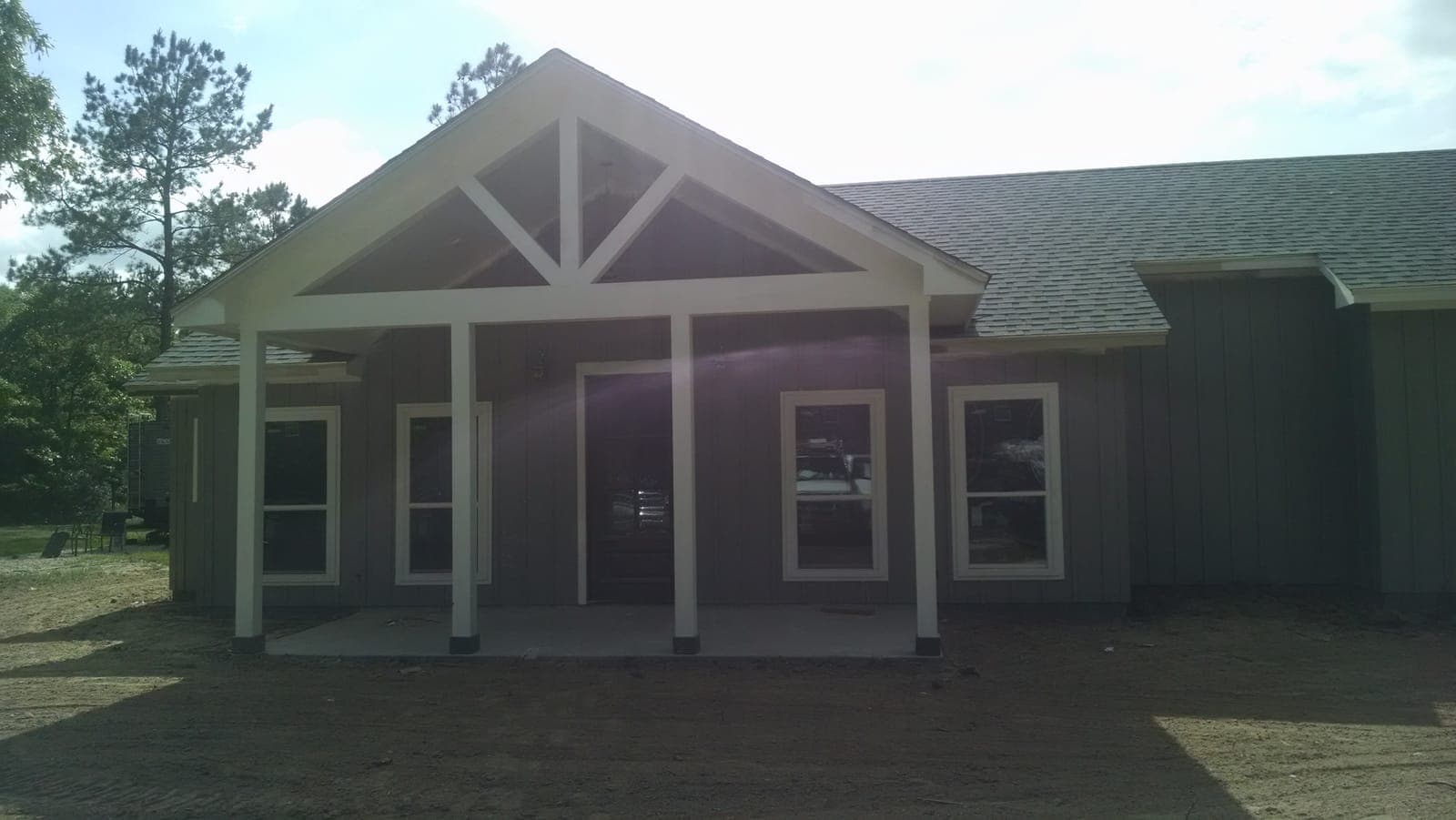 Custom porch with timber truss and board-and-batten