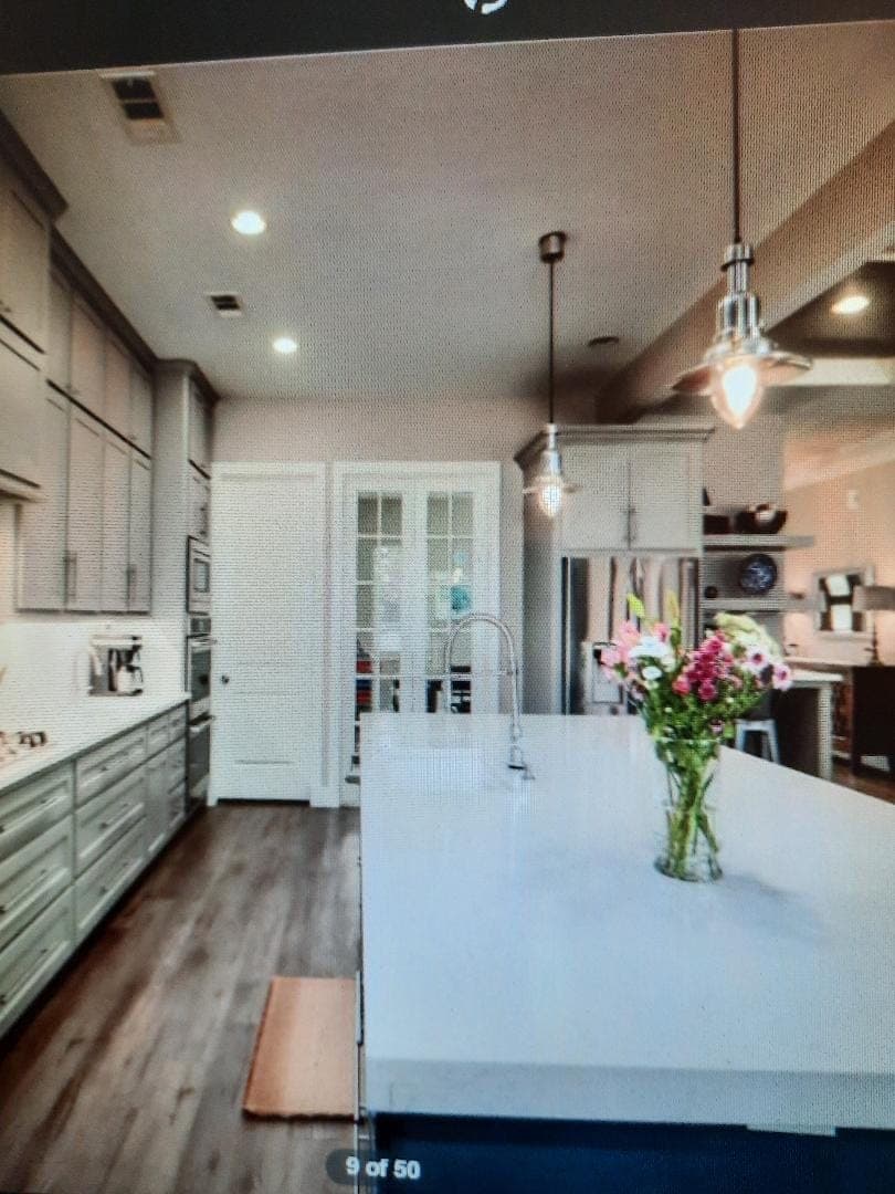 Modern kitchen with navy island and white counters