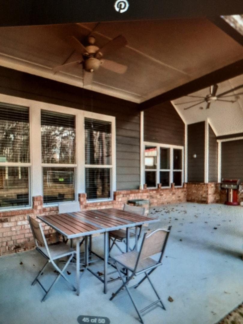 Covered outdoor patio with brick wainscoting