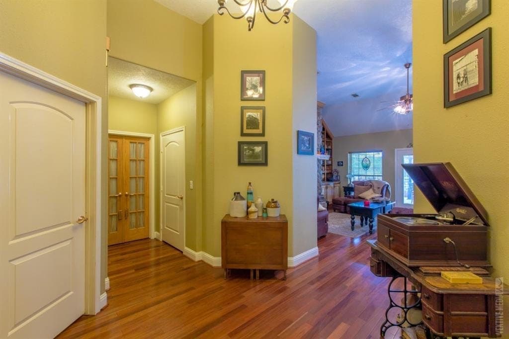 Foyer with hardwood floors and living room beyond