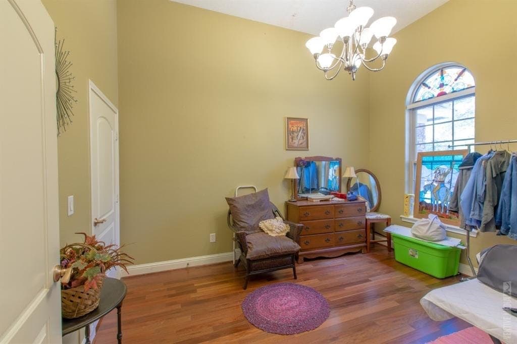 High-ceiling room with arched stained-glass window