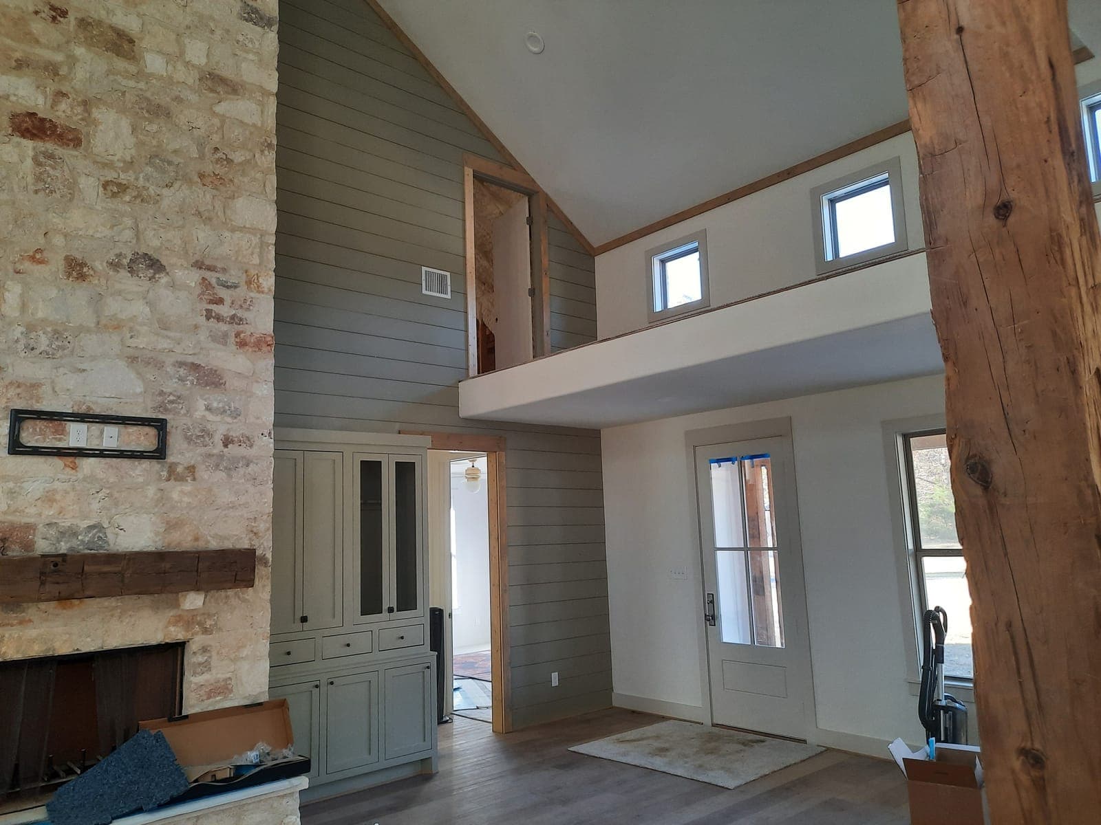 Vaulted great room with stone fireplace and loft
