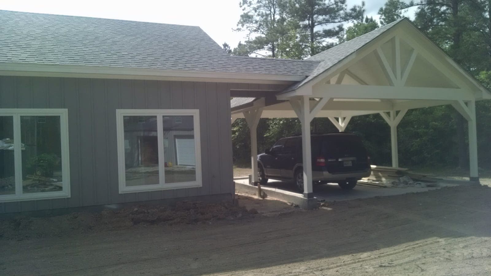 Attached carport with timber truss detailing