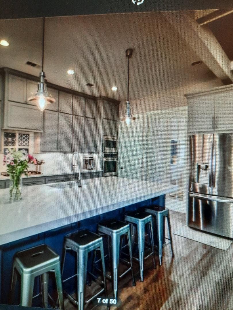 Kitchen with navy island and patterned backsplash