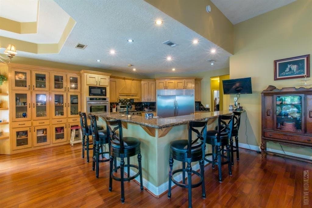 Kitchen breakfast bar with custom wood cabinetry