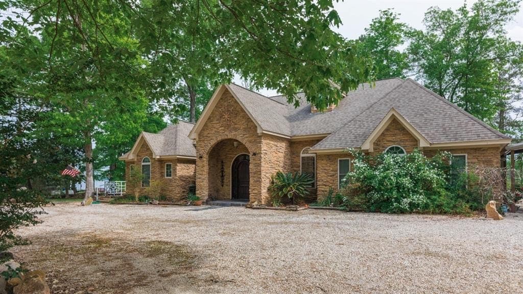 Full stone exterior custom home with arched portico