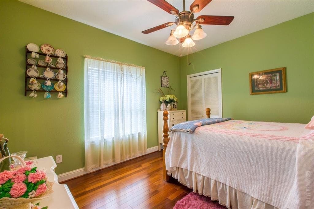 Bedroom with hardwood floors and finished trim
